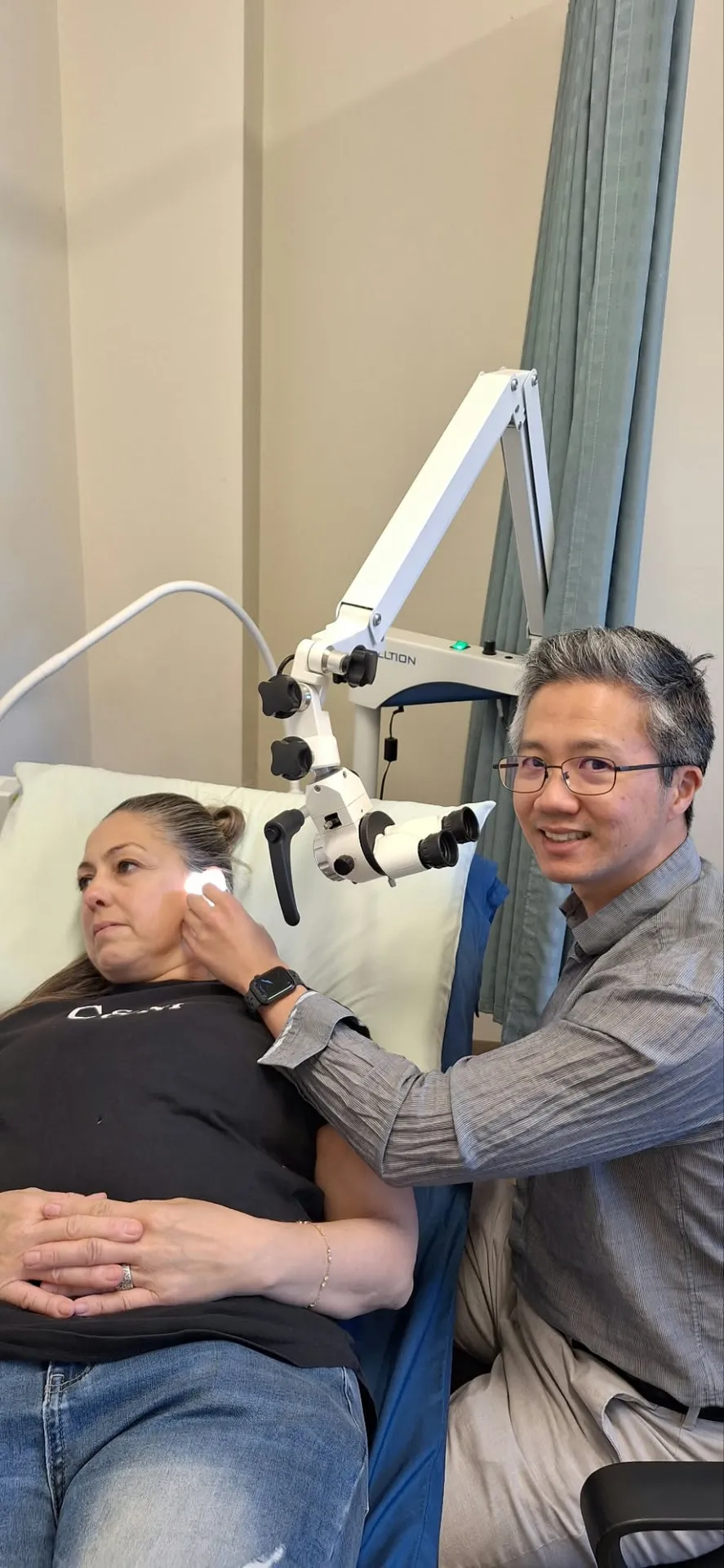 Doctor performing ear microsuction on a patient using a microscope at Balwyn Health Care